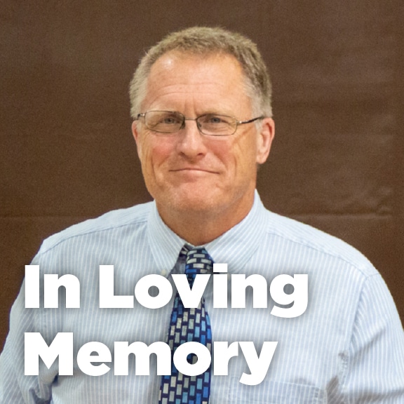 In Loving Memory tribute at children's science center featuring a man in glasses and tie.